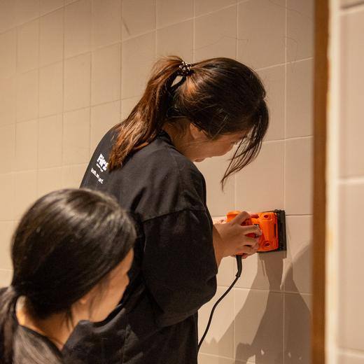 Sanding the wall back before any paint goes on